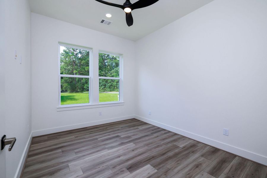 Second bedroom with canned lights and ceiling fan