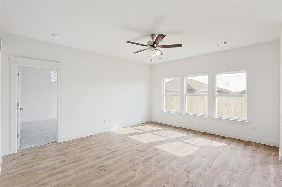 Unfurnished room with ceiling fan and light hardwood / wood-style flooring