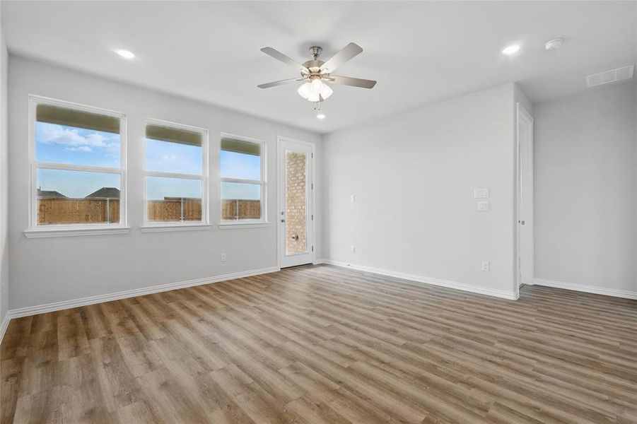 Spare room with ceiling fan, wood finished floors, and recessed lighting Spare room with ceiling fan, wood finished floors, and recessed lighting