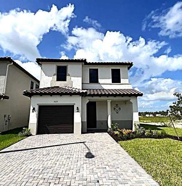 Front exterior of a new home in , Ave Maria, FL, highlighting curb appeal (Image 1).
