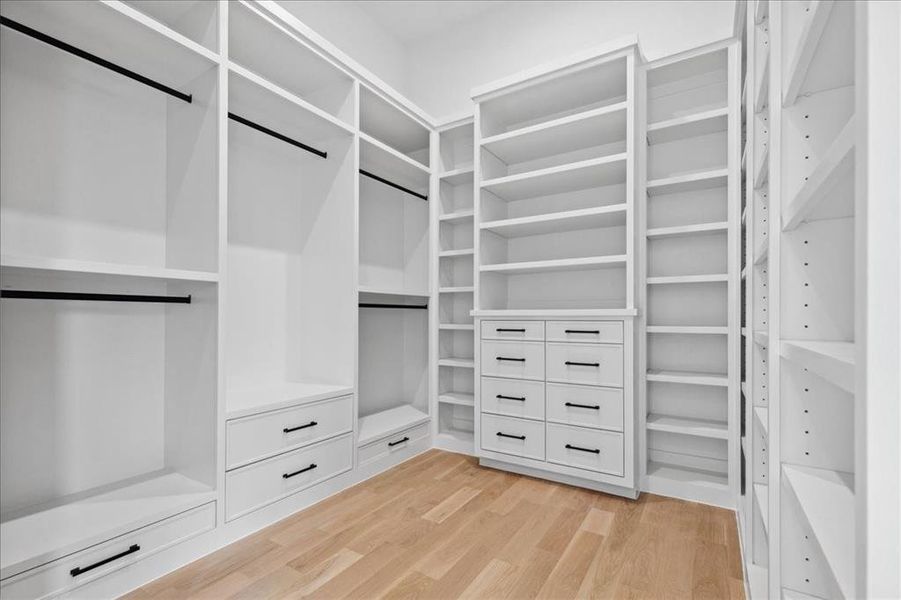 Walk in closet with light wood-type flooring