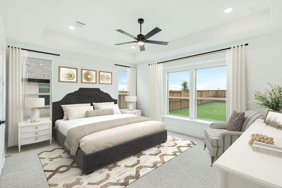 Master bedroom with dark upholstered bed, ceiling fan, and large windows overlooking a backyard