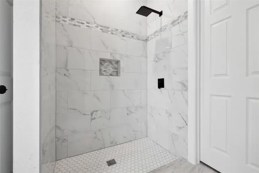 Full bathroom with a tile shower Full bathroom with a tile shower