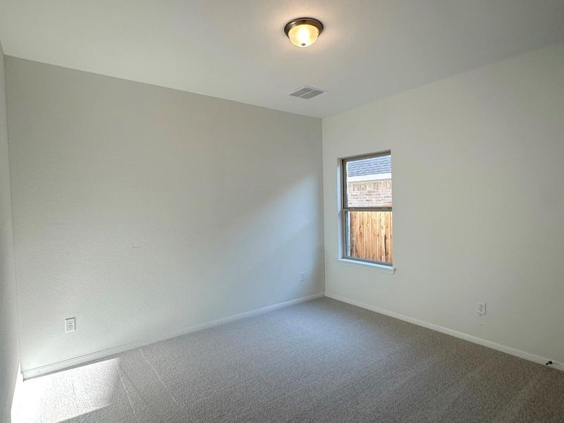 Carpeted spare room featuring baseboards Carpeted spare room featuring baseboards