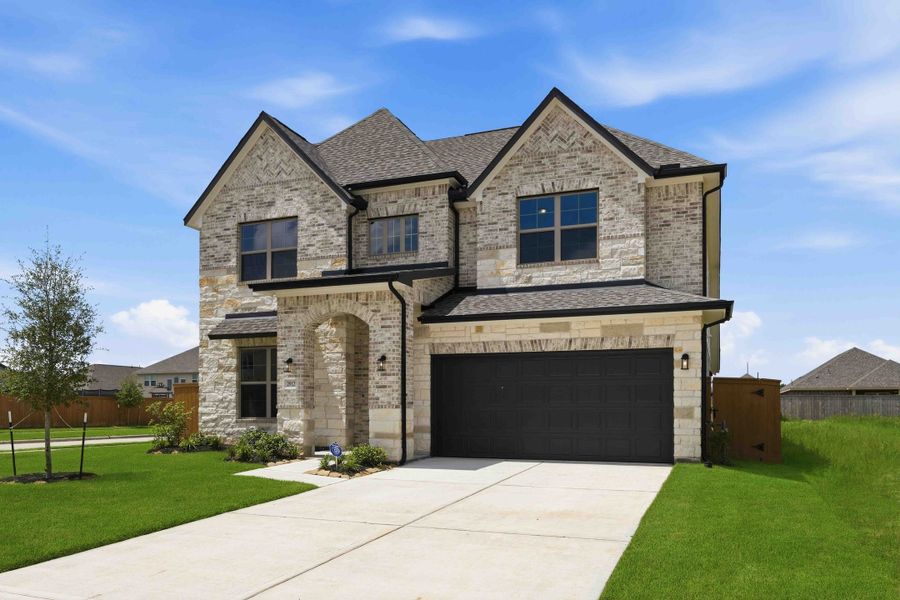 Front exterior of a new home in Sunterra 50s, Katy, TX, highlighting curb appeal (Image 2).