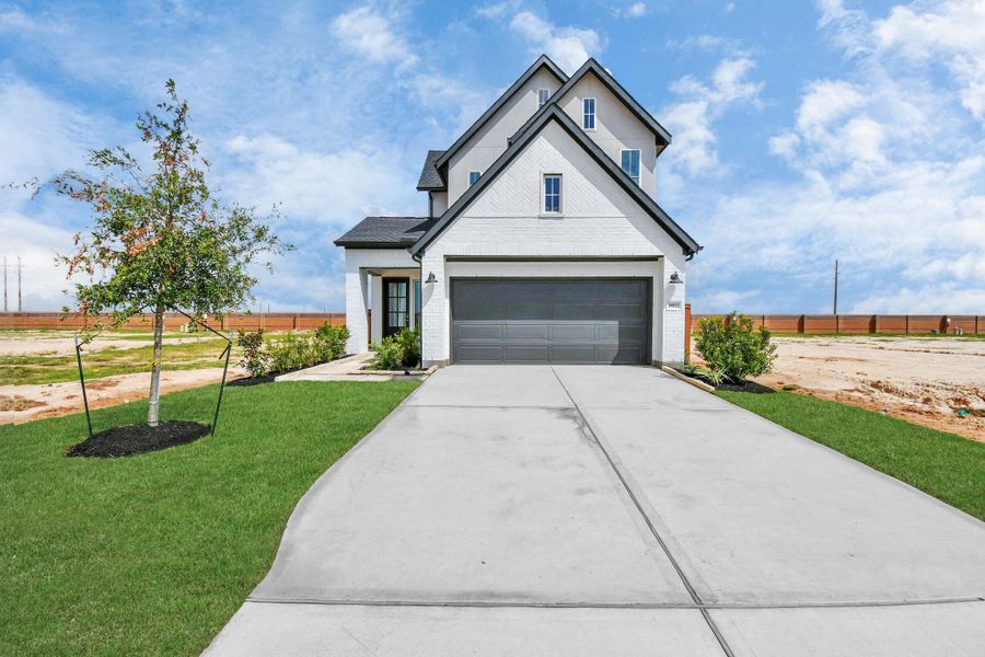 Front exterior of a new home in Elyson, Katy, TX, highlighting curb appeal (Image 22).