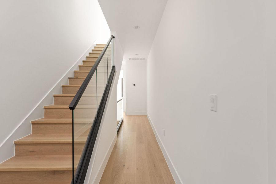 Staircase featuring wood finished floors and baseboards
