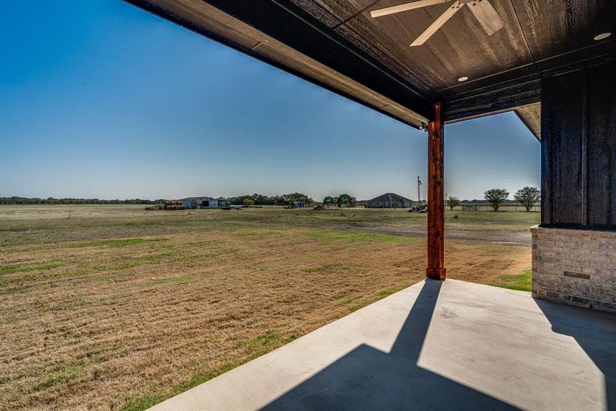 View of yard with a rural view and a patio area