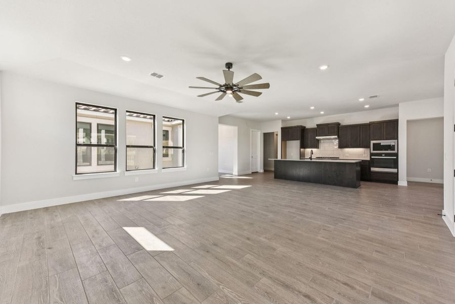 Unfurnished living room with recessed lighting, light wood-style floors, and ceiling fan Unfurnished living room with recessed lighting, light wood-style floors, and ceiling fan