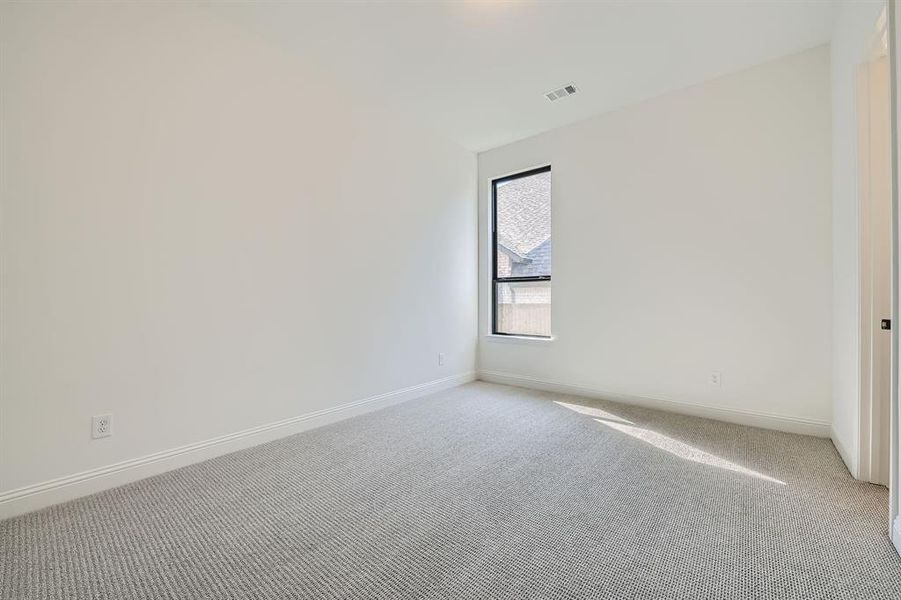 Spare room featuring light colored carpet