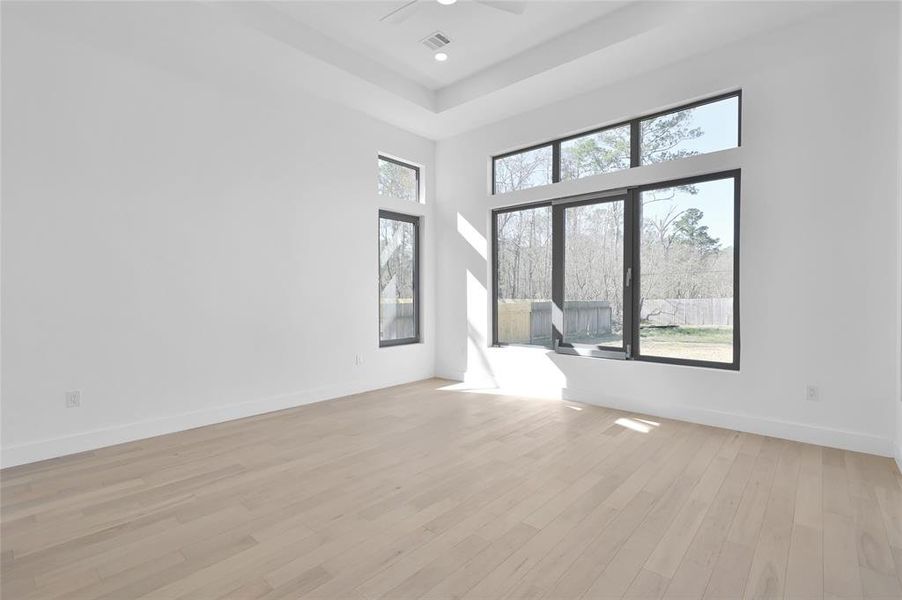 Sunlit and spacious primary bedroom.