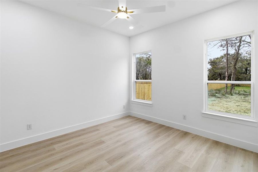 Spare room featuring light wood-type flooring, recessed lighting, and a ceiling fan