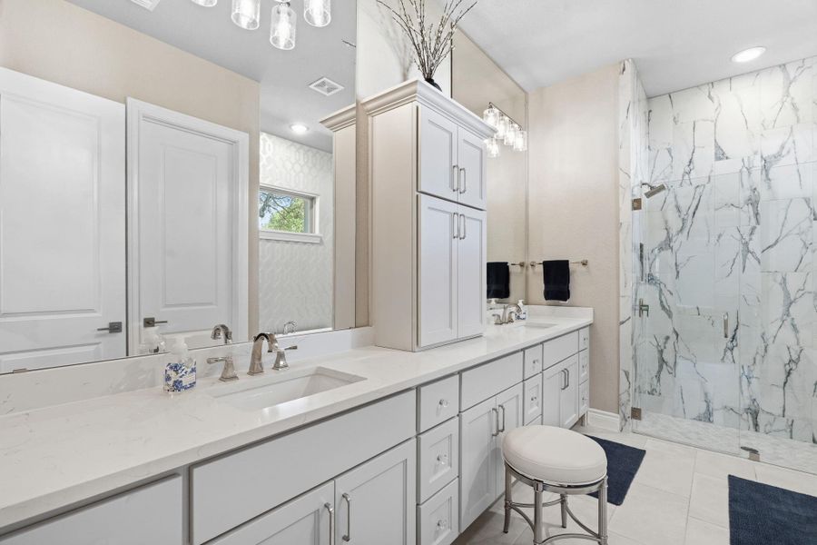 The spa-inspired primary bath features designer finishes throughout. The spa-inspired primary bath features designer finishes throughout.
