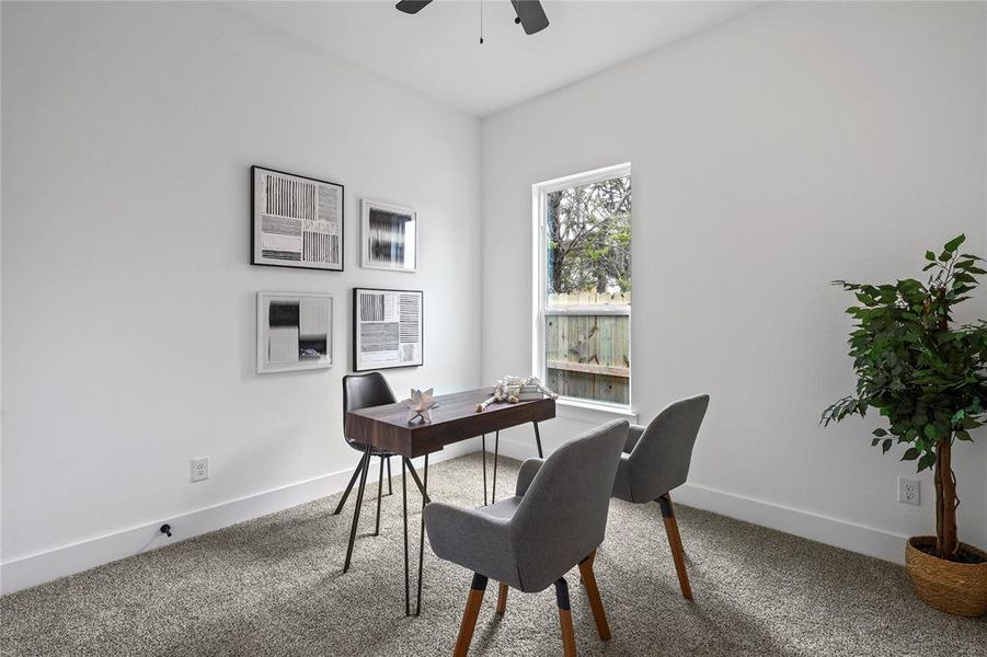 Home office featuring carpet, ceiling fan, and baseboards