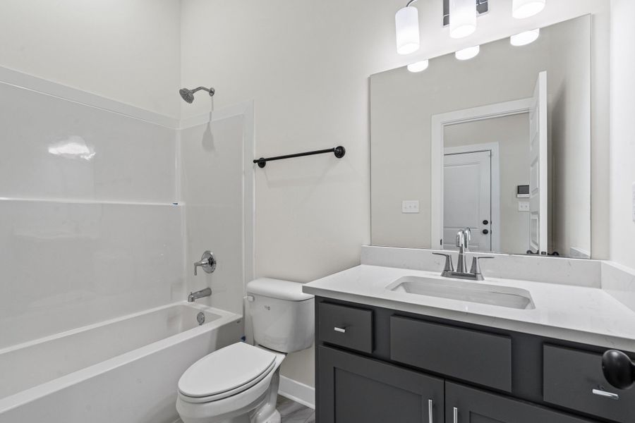 Full bathroom featuring vanity and washtub / shower combination Full bathroom featuring vanity and washtub / shower combination