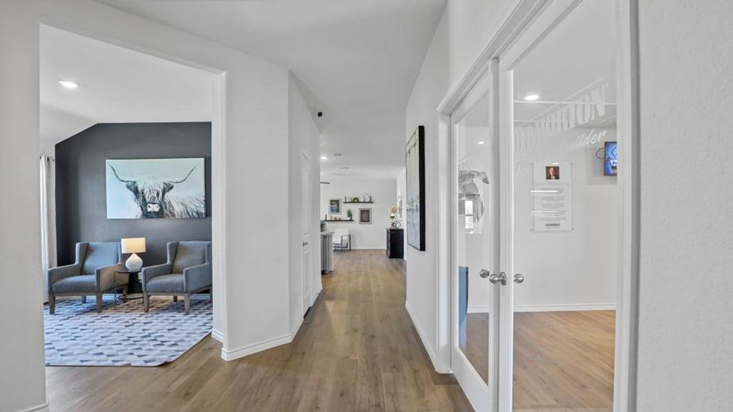 Corridor featuring light wood-style floors and recessed lighting