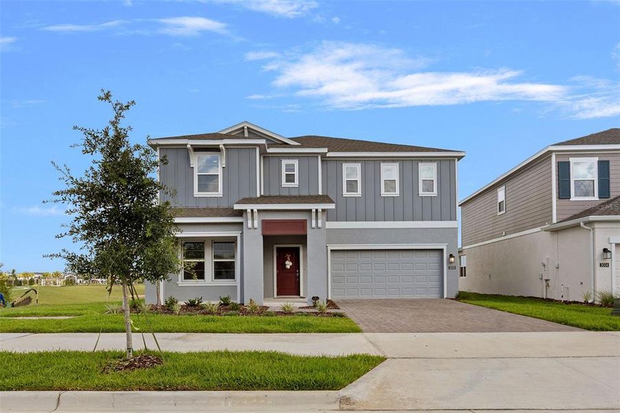 Front exterior of a new home in Wellness Ridge, Clermont, FL, highlighting curb appeal (Image 2).