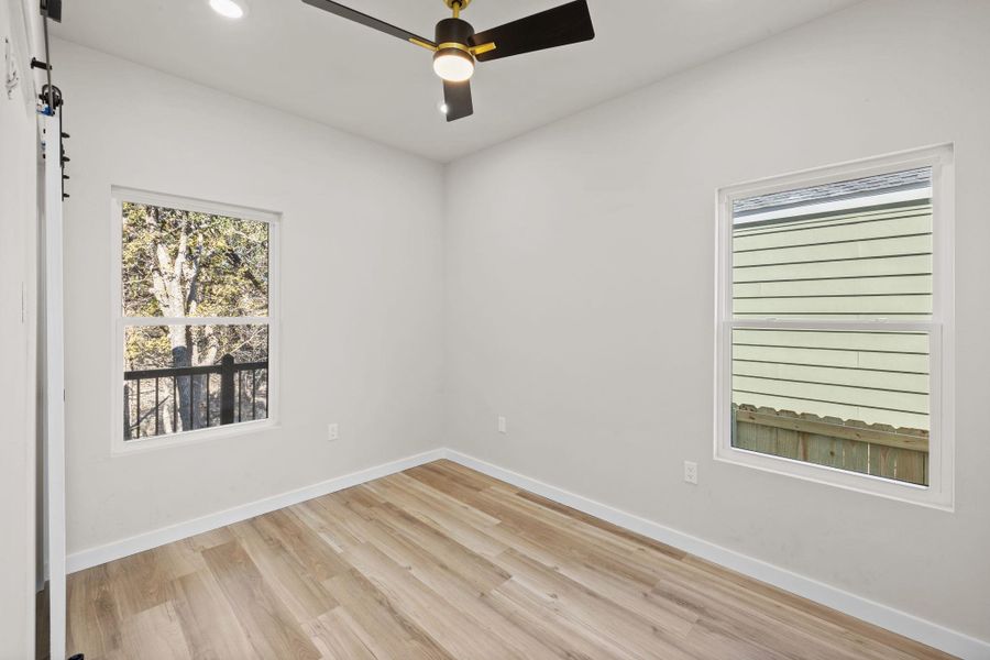 Spare room with light wood-style floors, a ceiling fan, plenty of natural light, and recessed lighting Spare room with light wood-style floors, a ceiling fan, plenty of natural light, and recessed lighting