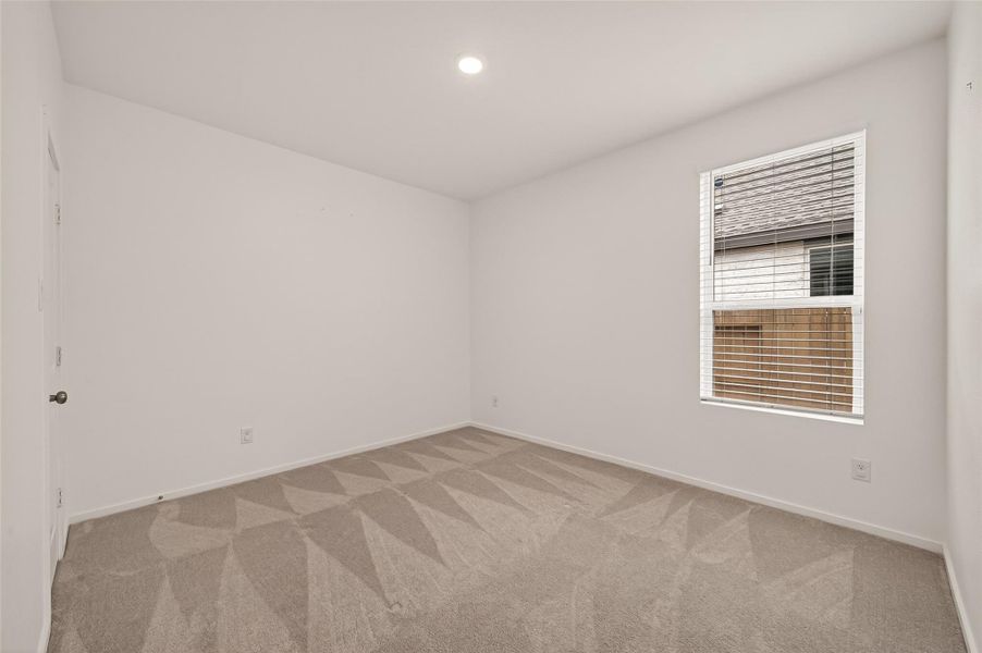 Versatile secondary bedroom with a clean, comfortable layout ideal for guests, family, or a productive work-from-home setup.