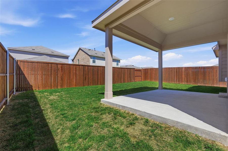Fenced backyard featuring a patio