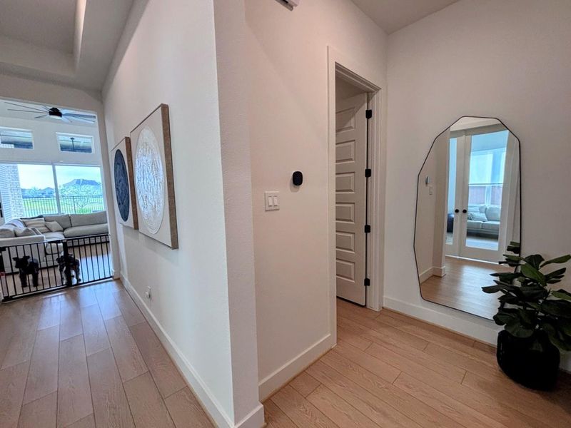 Hallway leading to the laundry room, utility room,3-car garage and living room.