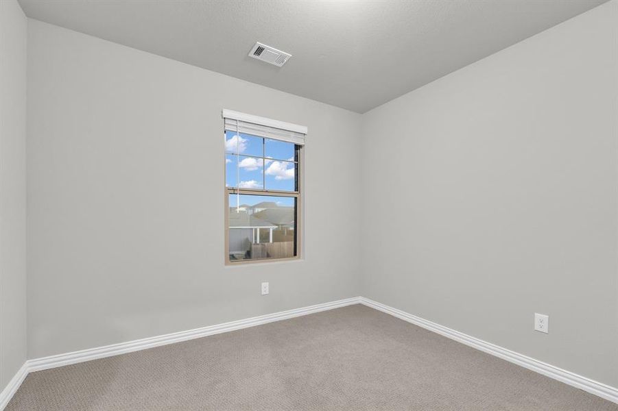 Spare room featuring carpet flooring