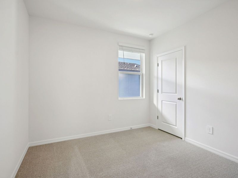 Spacious, unfurnished interior of a new home in The Grove at Stuart Crossing - Premier Series, Bartow (Image 11).