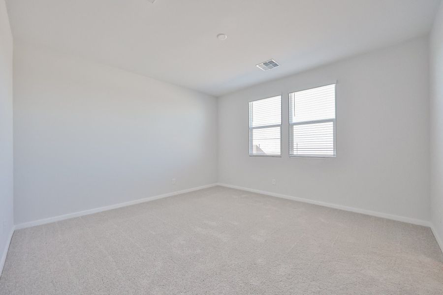 A room with a window and a carpet. A room with a window and a carpet.