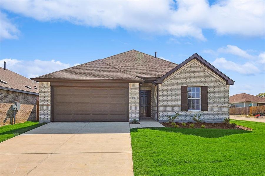 Ranch-style house featuring a garage and a front lawn