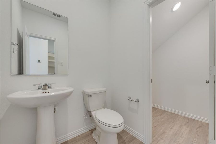 Bathroom with toilet and hardwood / wood-style floors