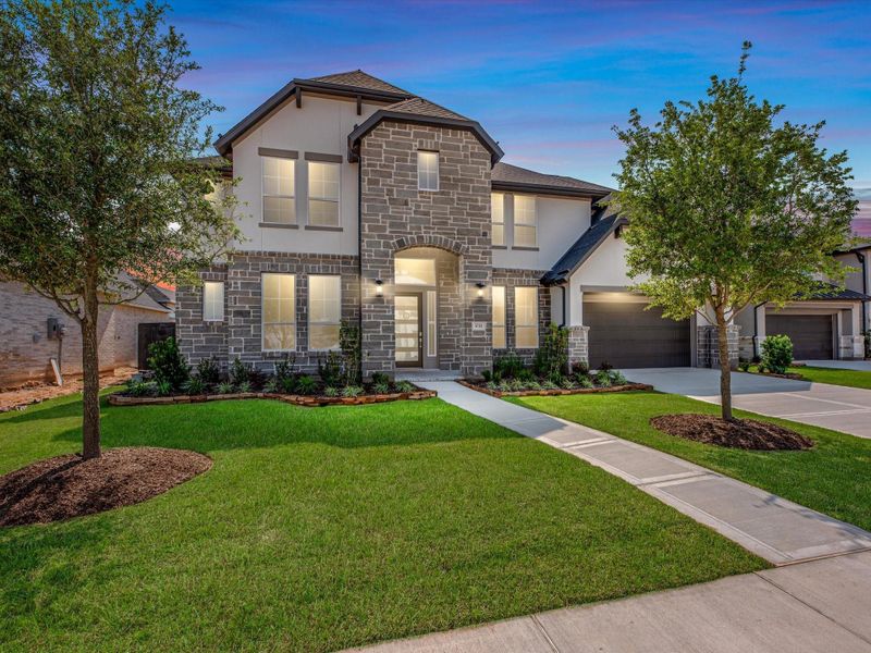 Front exterior of a new home in Harvest Green, Richmond, TX, highlighting curb appeal (Image 1). Front exterior of a new home in Harvest Green, Richmond, TX, highlighting curb appeal (Image 1).