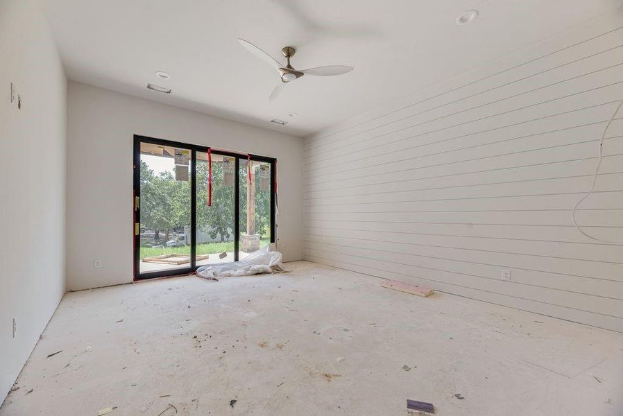 Primary bedroom with large sliding glass doors to access the large covered front patio. Primary bedroom with large sliding glass doors to access the large covered front patio.