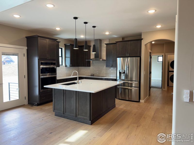 light premium quartz countertops blend well with darker 42" custom wood cabinets.