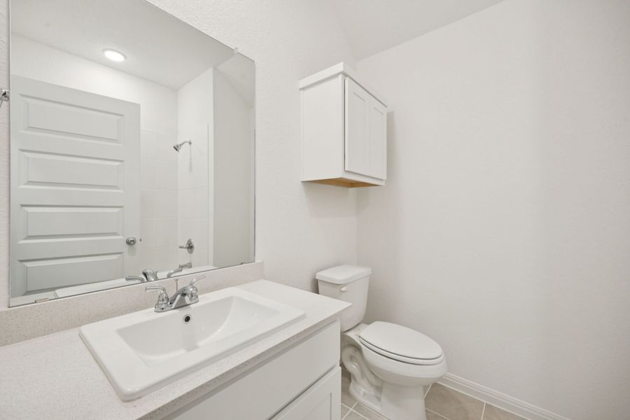 Bathroom in the Redbud home plan by Trophy Signature Homes - REPRESENTATIVE PHOTO