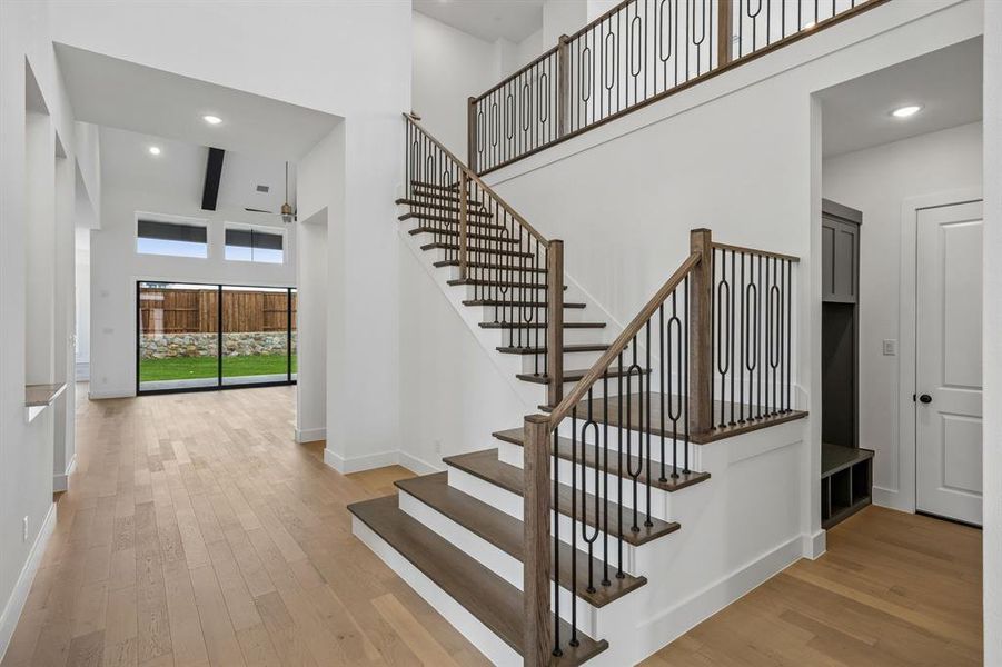 Offering sight lines from the front through to the rear of the home and an elegant warp around staircase with stylish railings and wood treads, this stunning entry area provides the perfect space to welcome family and friends!