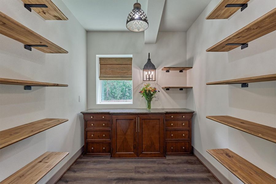 This impressive walk-in pantry offers abundant storage for pantry essentials, small appliances and kitchen gadgets helping keep the kitchen organized and clutter-free