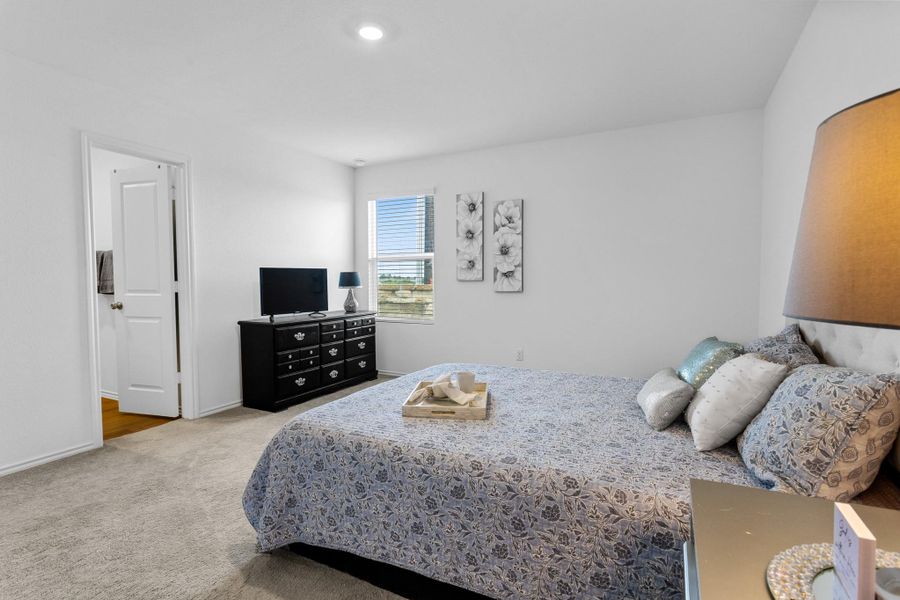 Carpeted room with a recessed ceiling light, a window with horizontal blinds, and a white paneled door