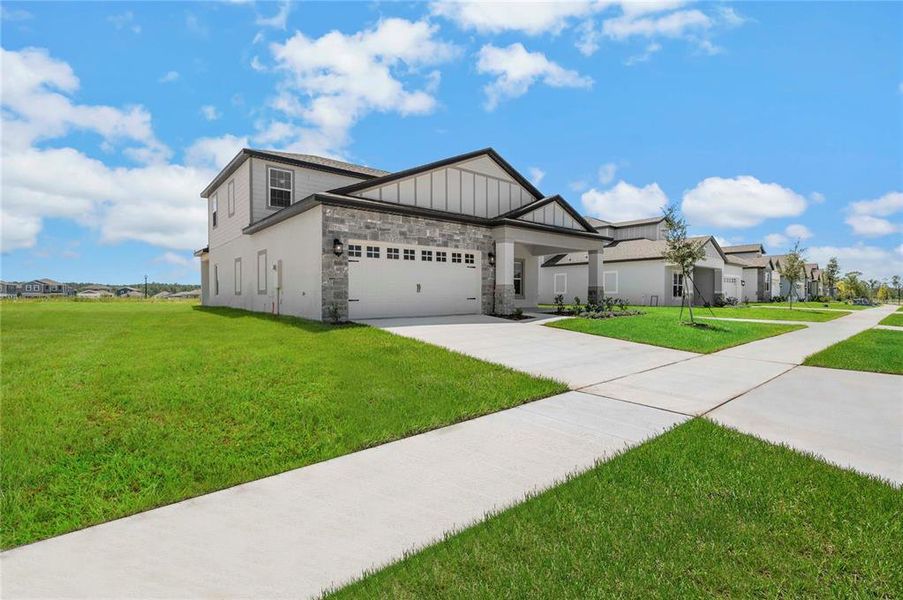 Front exterior of a new home in Gum Lake Preserve, Lake Alfred, FL, highlighting curb appeal (Image 20).