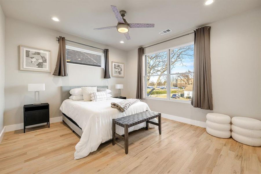 Bedroom with ceiling fan and light wood-type flooring