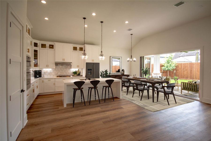 Experience the allure of an open floor plan that beautifully connects an elegant kitchen and dining area, creating an inviting space where indoor and outdoor living come together seamlessly. Virtually stage Experience the allure of an open floor plan that beautifully connects an elegant kitchen and dining area, creating an inviting space where indoor and outdoor living come together seamlessly. Virtually stage