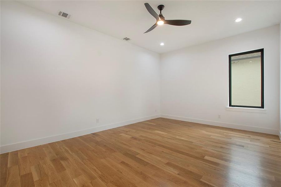 Empty room featuring light hardwood / wood-style flooring and ceiling fan