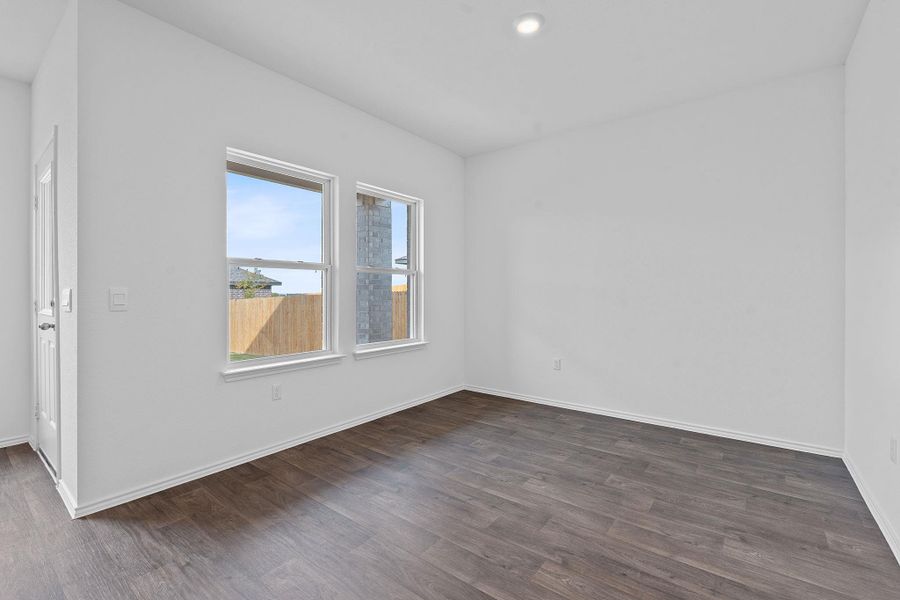 Empty room with dark wood-style floors and recessed lighting Empty room with dark wood-style floors and recessed lighting