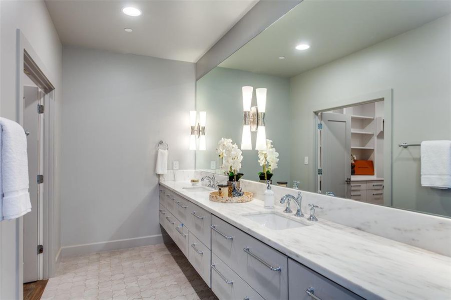 Bathroom with double sink vanity and tile patterned flooring