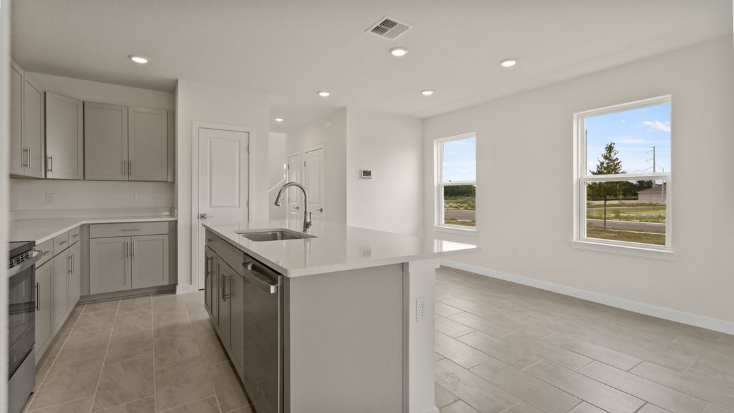 The Naples Kitchen with large Island Quick Move-In Home at Willowbrook North by DRB Homes in Winter Haven, FL The Naples Kitchen with large Island Quick Move-In Home at Willowbrook North by DRB Homes in Winter Haven, FL