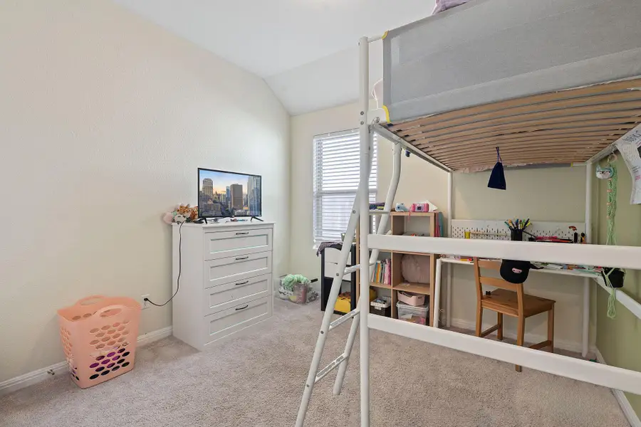 Bedroom with light carpet and vaulted ceiling Bedroom with light carpet and vaulted ceiling