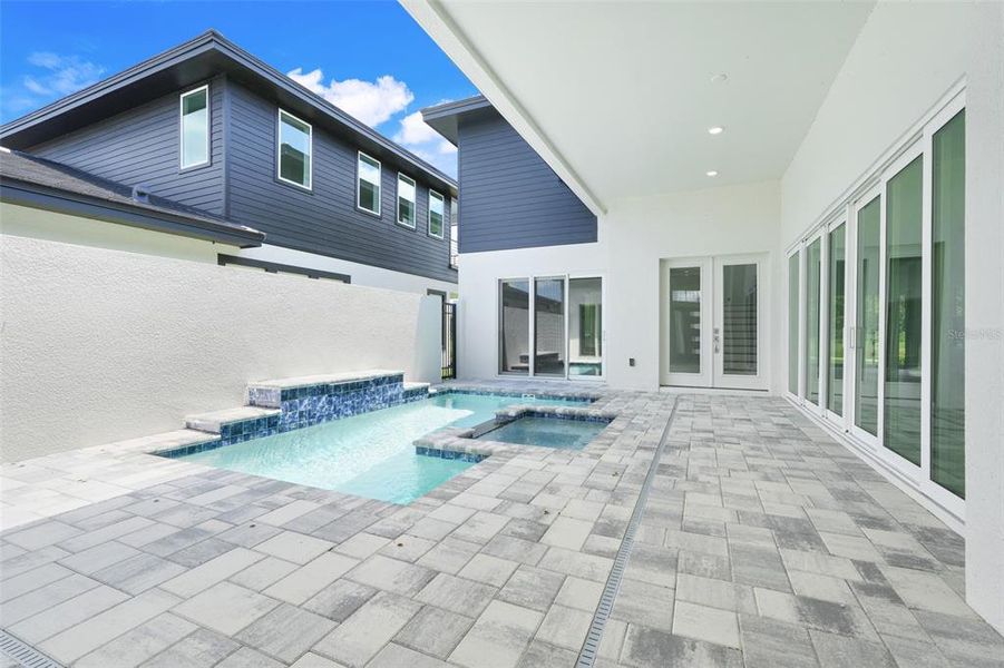 Exterior details and patio area of a home in Hampton Green at Providence, Davenport (Image 33).