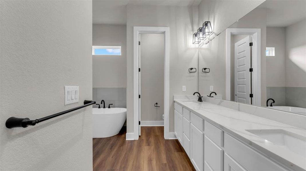 Clean lines and modern fixtures define this light-filled bath featuring a spacious double vanity. Clean lines and modern fixtures define this light-filled bath featuring a spacious double vanity.