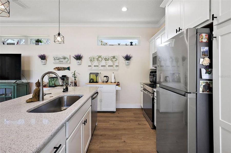 The elegant kitchen with stainless appliances and quartz counter tops.