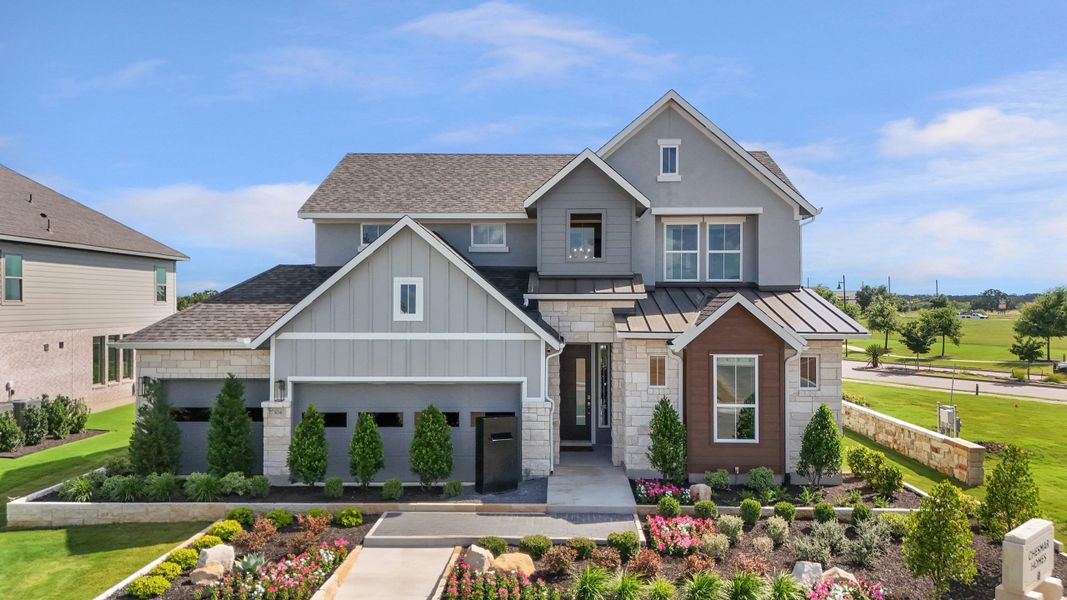 Front exterior of a new home in Lariat, Liberty Hill, TX, highlighting curb appeal (Image 28). Front exterior of a new home in Lariat, Liberty Hill, TX, highlighting curb appeal (Image 28).