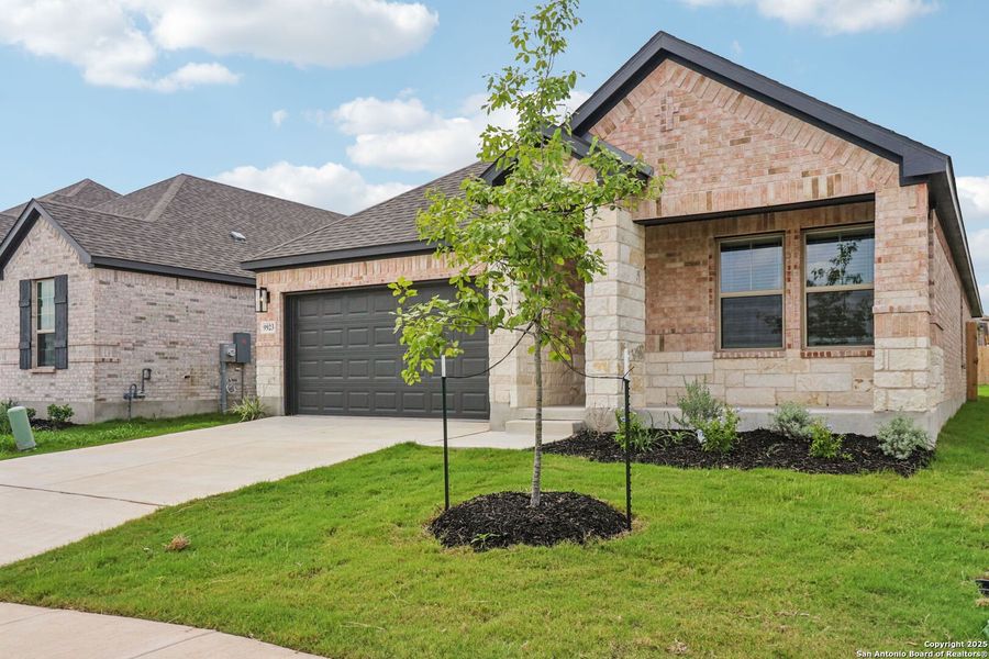 Front exterior of a new home in Kallison Ranch, San Antonio, TX, highlighting curb appeal (Image 2). Front exterior of a new home in Kallison Ranch, San Antonio, TX, highlighting curb appeal (Image 2).